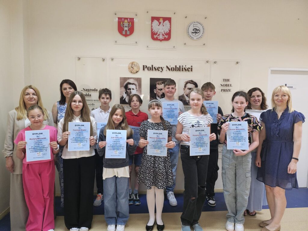 Uczniowie pozują z dyplomami